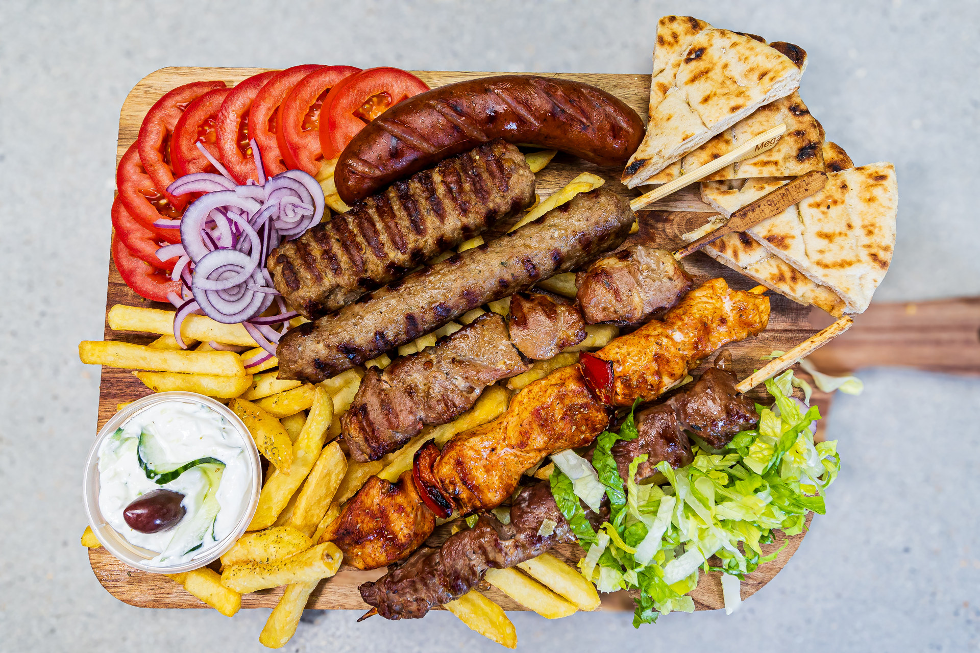 Mixed grill for two with pork, chicken, lamb, sausage, kebab and kebab Philadelphia served with pitta and fries - Cristinas Greek Souvlaki Daventry